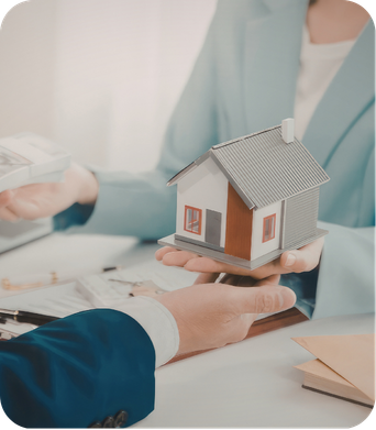 Person holding a model house